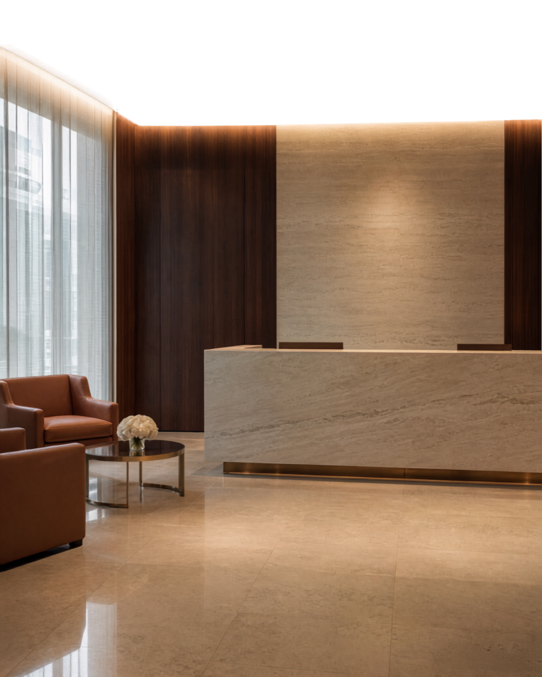 A marble reception desk and lounge seating in an office lobby